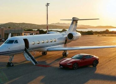 Private jet parked at Italian airport with luxury car transfer.