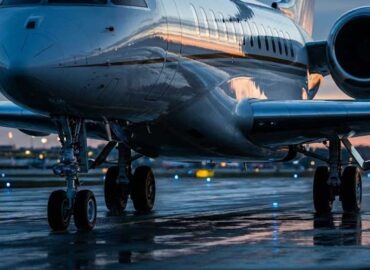 Large private jet taxiing on runway representing higher rate air passenger duty tax.