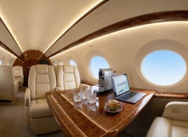 Luxurious private jet interior with executive amenities and workspace setup