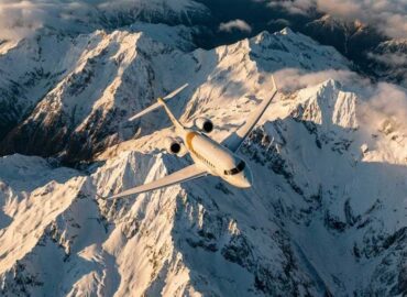 Private jet flying over the Andes mountains representing South America private jet charter.
