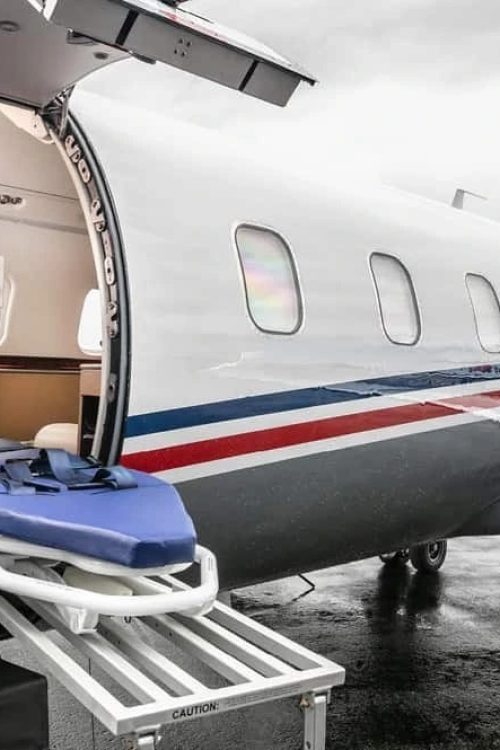 Medical Team Transferring A Patient From A Ground Ambulance To An Air Ambulance Jet.